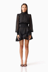 Brunette model wearing the Moss Long Sleeve Mini Dress in Black front shot