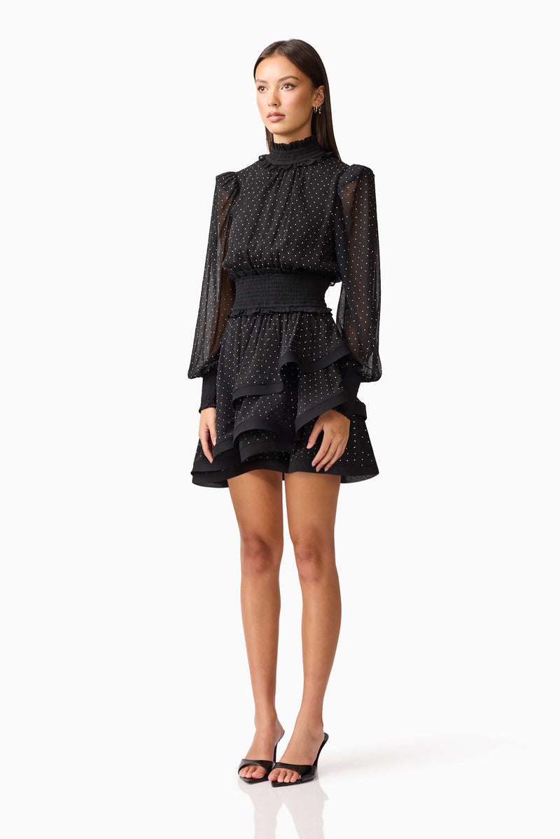 Brunette model wearing the Moss Long Sleeve Mini Dress in Black side shot