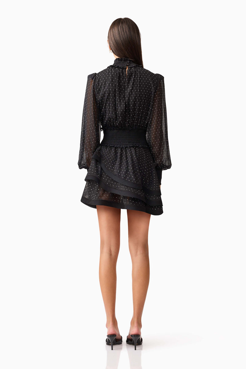 Brunette model wearing the Moss Long Sleeve Mini Dress in Black back shot