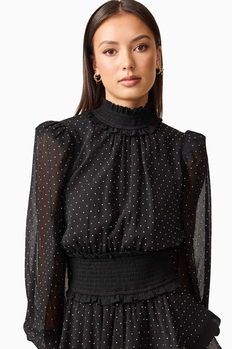 Brunette model wearing the Moss Long Sleeve Mini Dress in Black close up shot