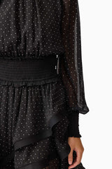 Brunette model wearing the Moss Long Sleeve Mini Dress in Black detail shot