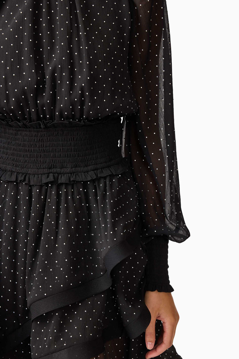 Brunette model wearing the Moss Long Sleeve Mini Dress in Black detail shot