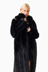 Blonde model wearing the Lux Faux Fur Coat in Black close up shot