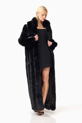 Blonde model wearing the Lux Faux Fur Coat in Black posed shot