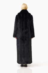 Blonde model wearing the Lux Faux Fur Coat in Black back shot