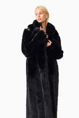 Blonde model wearing the Lux Faux Fur Coat in Black close up looking away shot