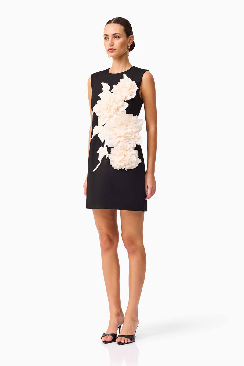 Brunette model wearing the Zahara Shift Mini Dress in Black side shot