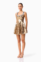 Brunette model wearing the Noelle Sequin Mini Dress in Gold side shot