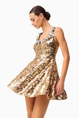 Brunette model wearing the Noelle Sequin Mini Dress in Gold close up posed shot