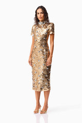 Brunette model wearing the Noelle Short Sleeve Midi Dress in Gold side shot