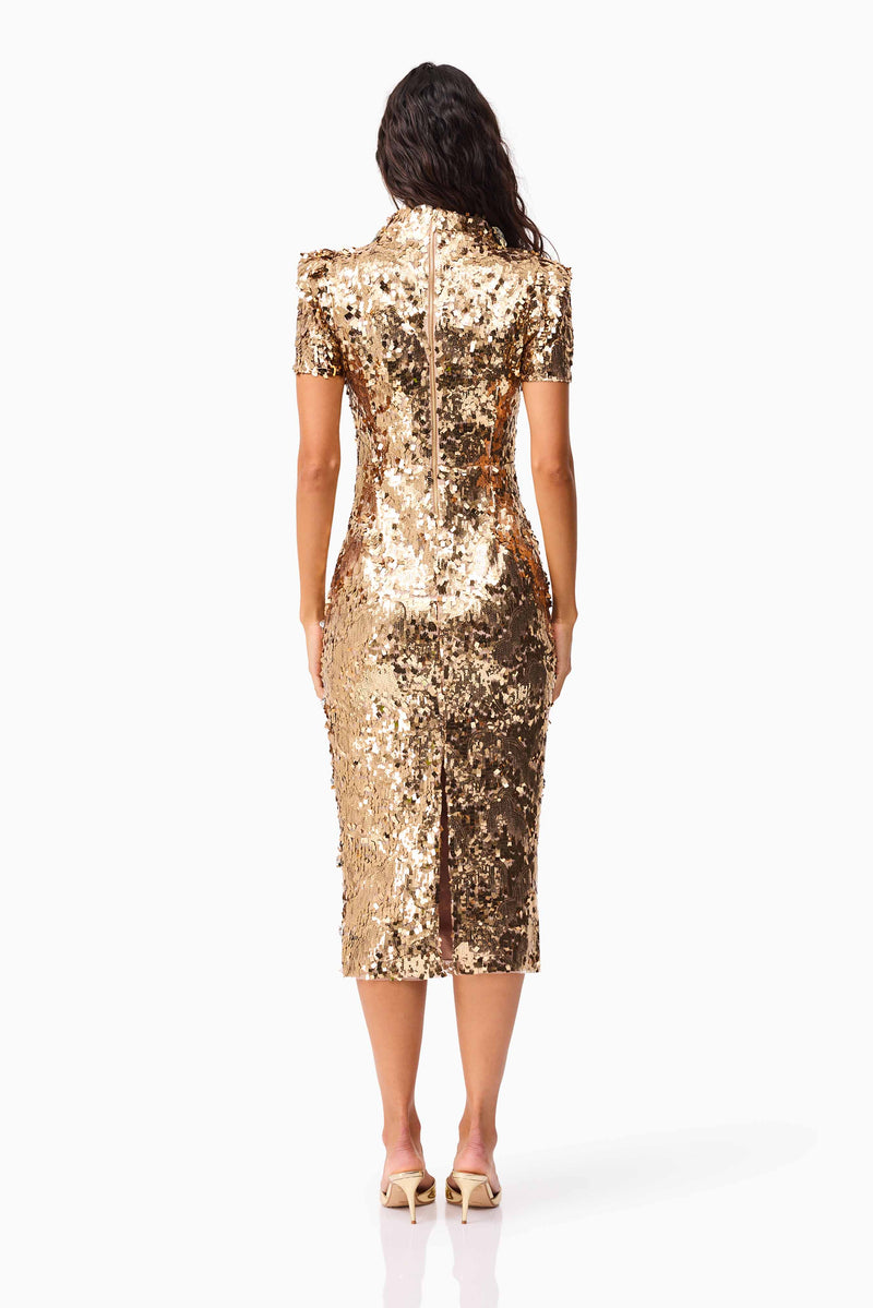 Brunette model wearing the Noelle Sequin Short Sleeve Midi Dress in Gold back shot