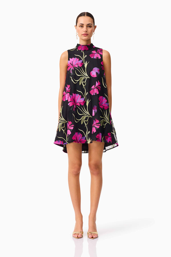 Brunette model wearing the Amaya High Neck Mini Dress in Black & Pink Floral front shot