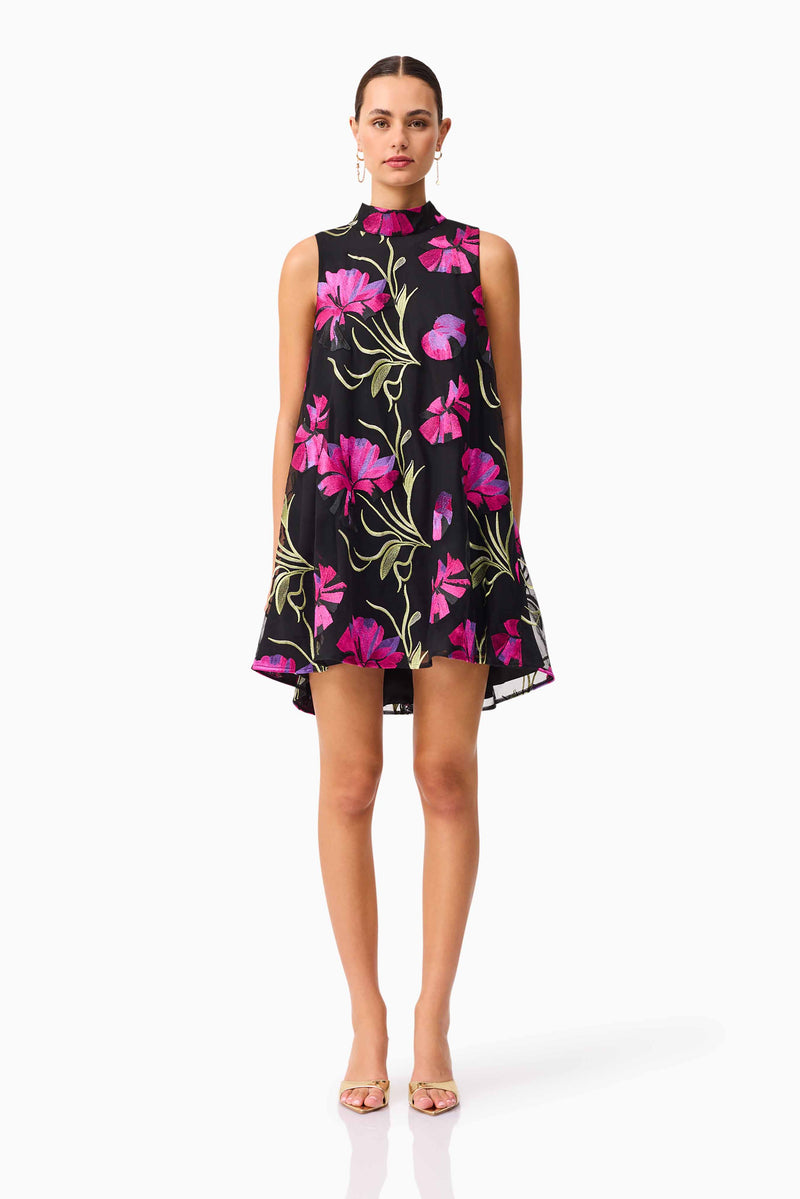 Brunette model wearing the Amaya High Neck Mini Dress in Black & Pink Floral front shot