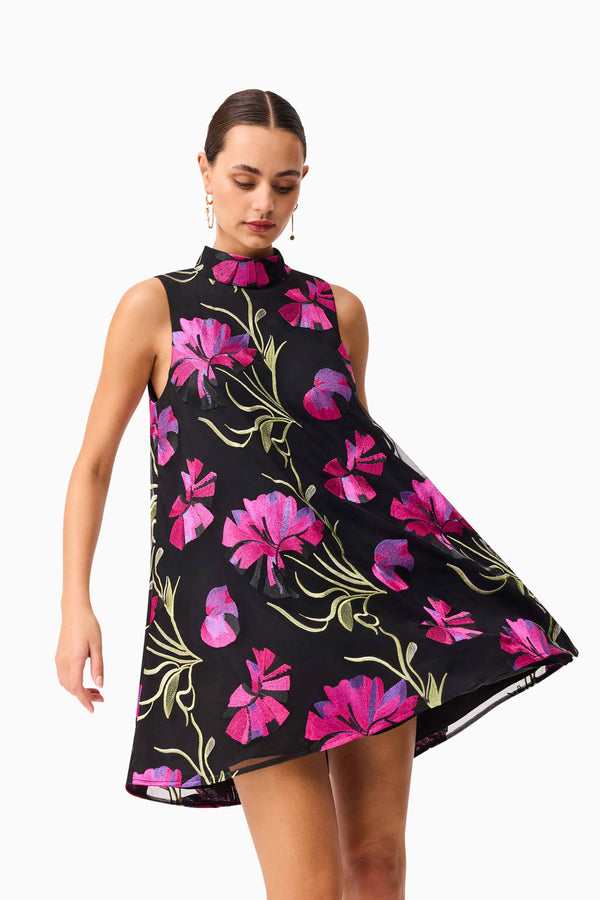 Brunette model wearing the Amaya High Neck Mini Dress in Black & Pink Floral close up shot