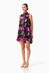 Brunette model wearing the Amaya High Neck Mini Dress in Black & Pink Floral side shot