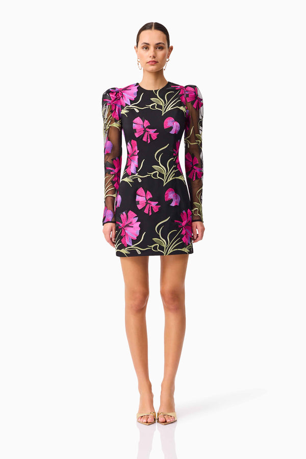 Brunette model wearing the Amaya Long Sleeve Mini Dress in Black & Pink Floral front shot