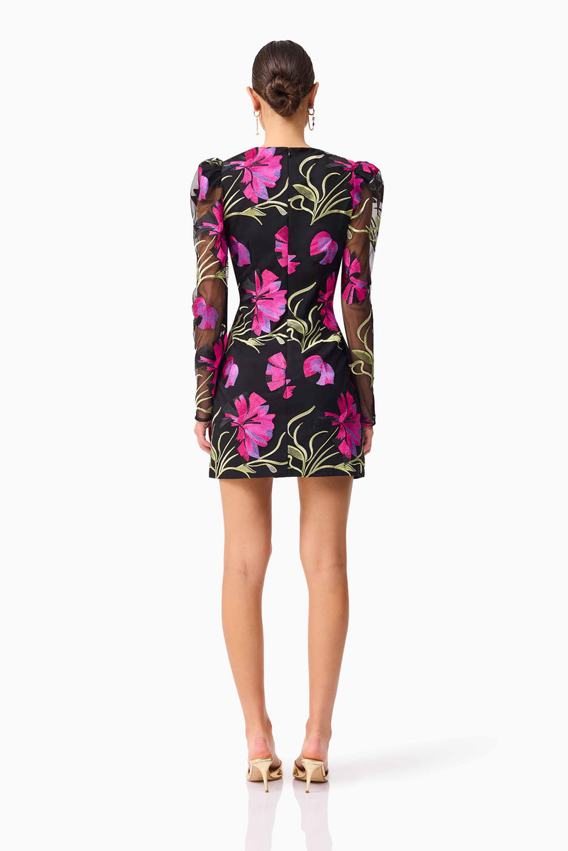 Brunette model wearing the Amaya Long Sleeve Mini Dress in Black & Pink Floral back shot