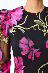 Brunette model wearing the Amaya Long Sleeve Mini Dress in Black & Pink Floral detail shot