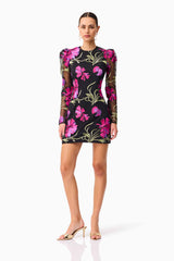 Brunette model wearing the Amaya Long Sleeve Mini Dress in Black & Pink Floral posed shot