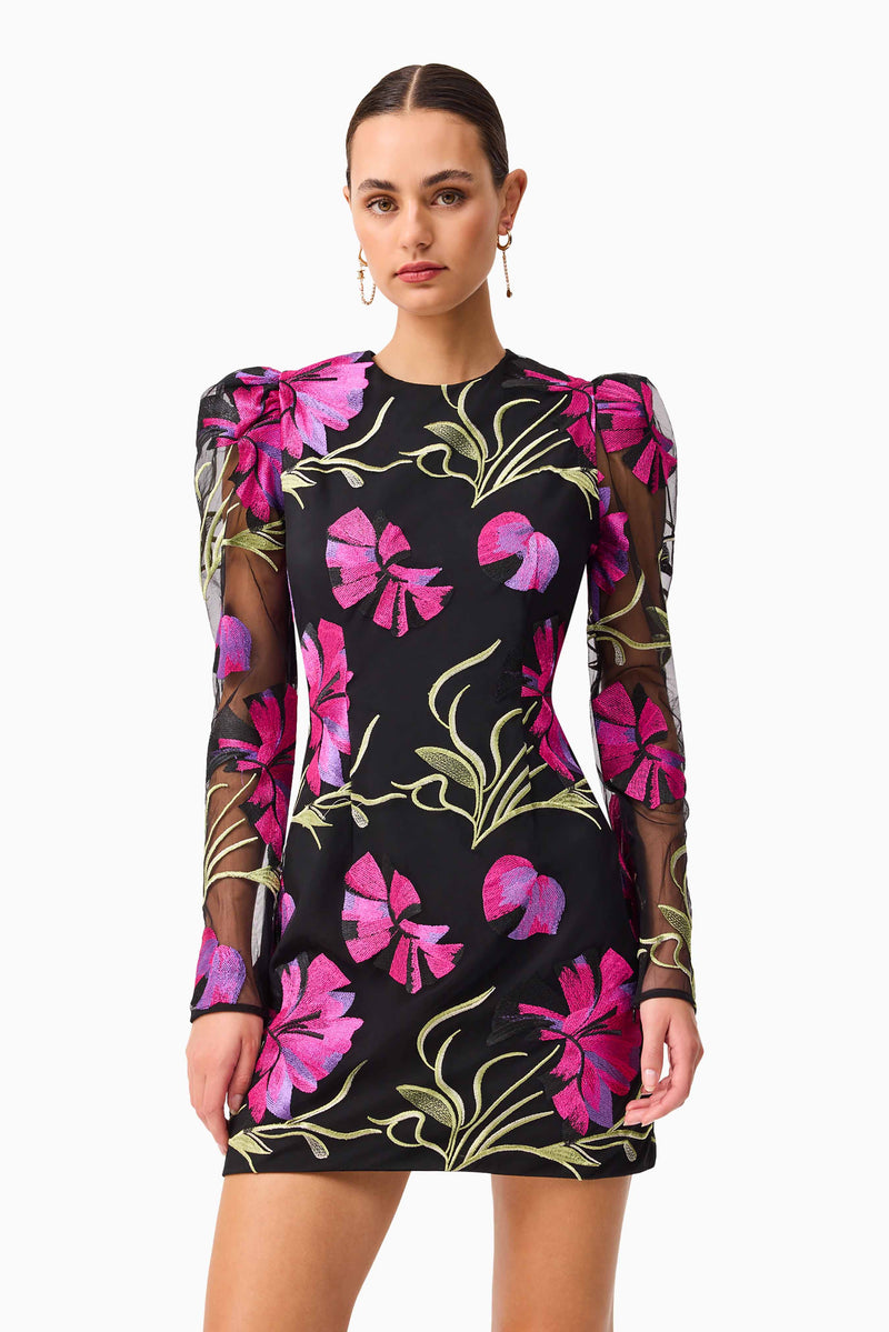 Brunette model wearing the Amaya Long Sleeve Mini Dress in Black & Pink Floral close up shot
