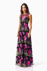 Brunette model wearing the Amaya Gown in Black & Pink Floral side shot