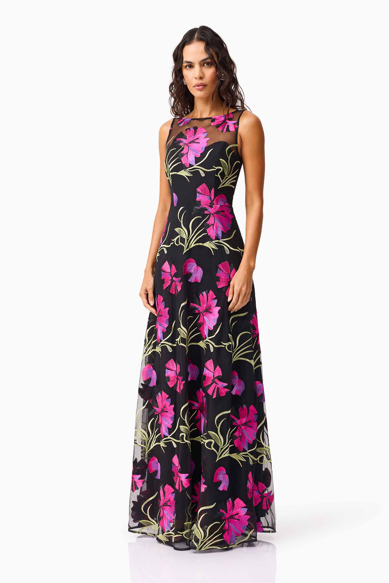 Brunette model wearing the Amaya Gown in Black & Pink Floral side shot