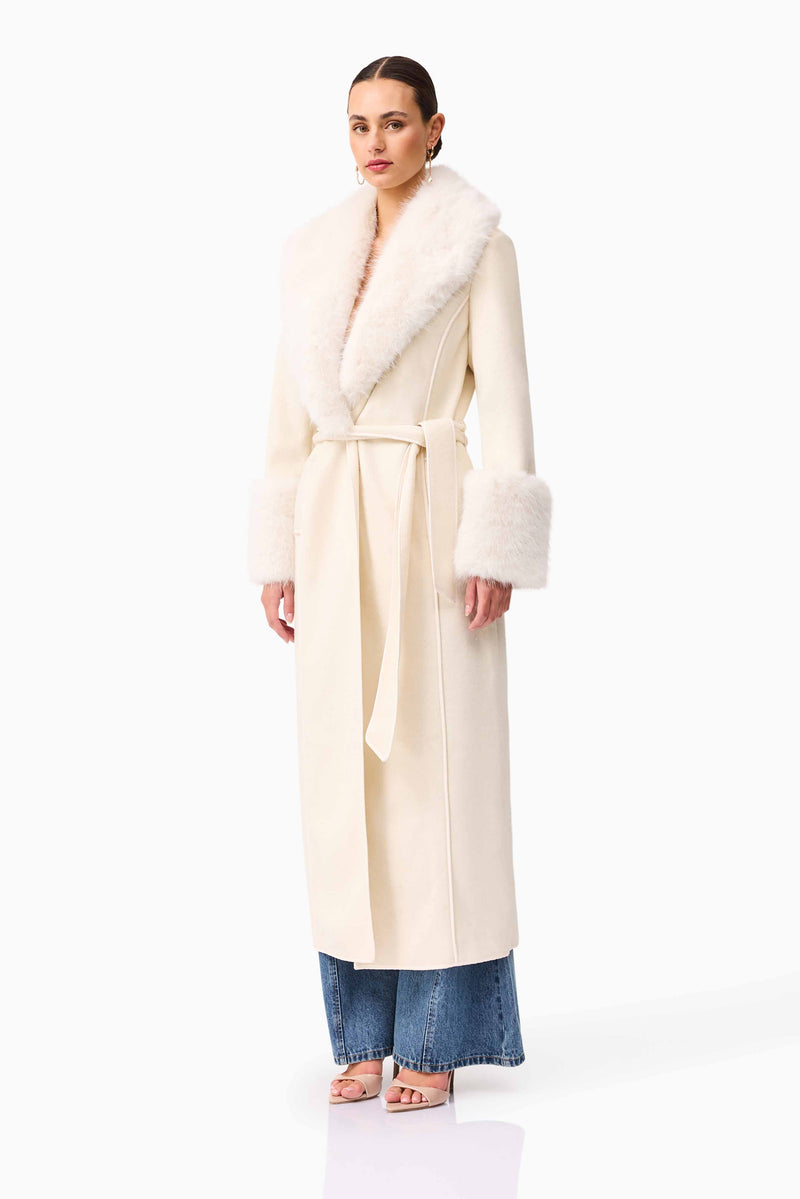 Brunette model wearing the Aria Coat in Cream side shot