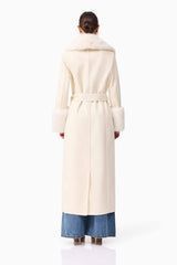 Brunette model wearing the Aria Coat in Cream back shot