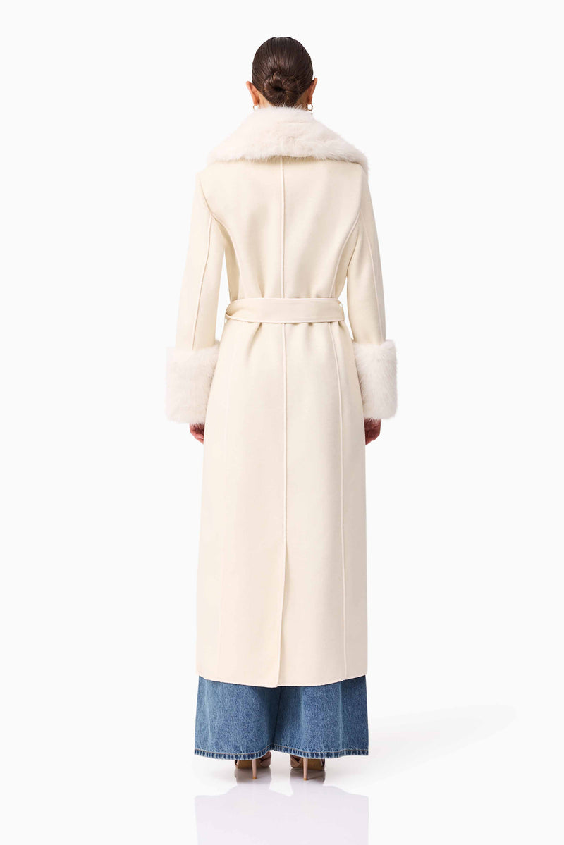 Brunette model wearing the Aria Coat in Cream back shot