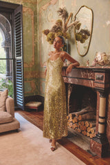 Model wearing the Mercelline Embellished Gown in Gold to a wedding reception 