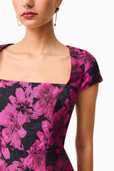 Brunette model wearing the Holly Short Sleeve Mini Dress in Pink & Black Floral detail shot