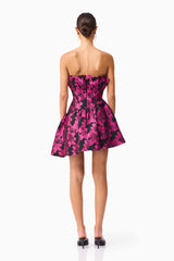 Brunette model wearing the Holly Asymmetrical Mini Dress in Pink & Black Floral back shot