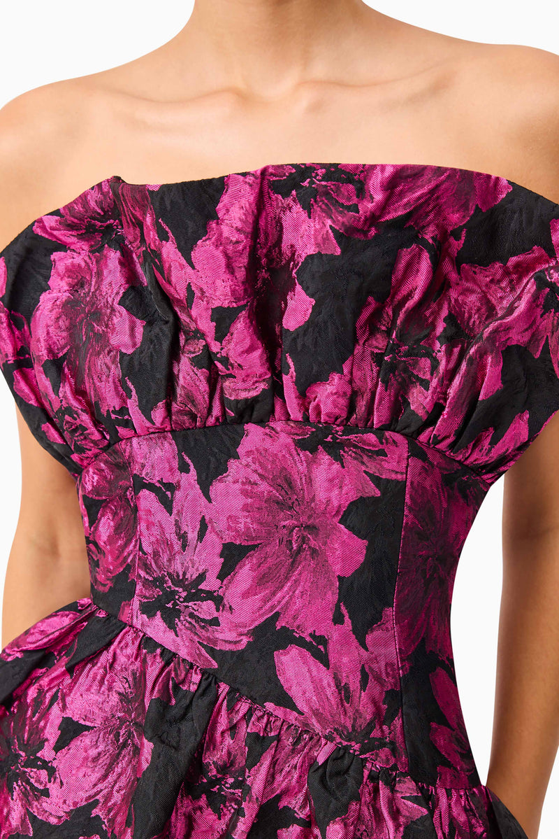 Brunette model wearing the Holly Asymmetrical Mini Dress in Pink & Black Floral detail shot