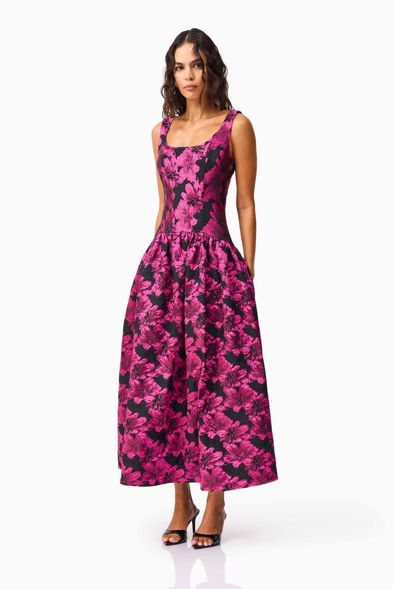 Brunette model wearing the Holly A-Line Gown in Pink & Black Floral side shot