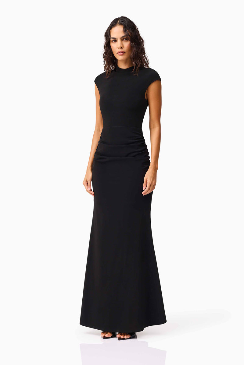 Brunette model wearing the Danica High Neck Gown in Black side shot