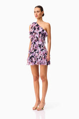Brunette model wearing the Solene One Shoulder Mini Dress in Purple Floral Side Shot