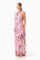 Brunette model wearing the Solene Halter Gown in Pink Floral side shot