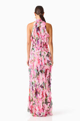 Brunette model wearing the Solene Halter Gown in Pink Floral back shot