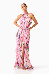 Brunette model wearing the Solene Halter Gown in Pink Floral posed hands on hips shot