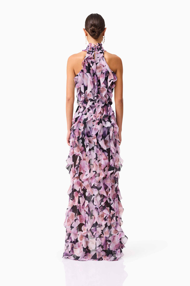 Brunette model wearing Solene Halter Gown in Purple Floral back shot