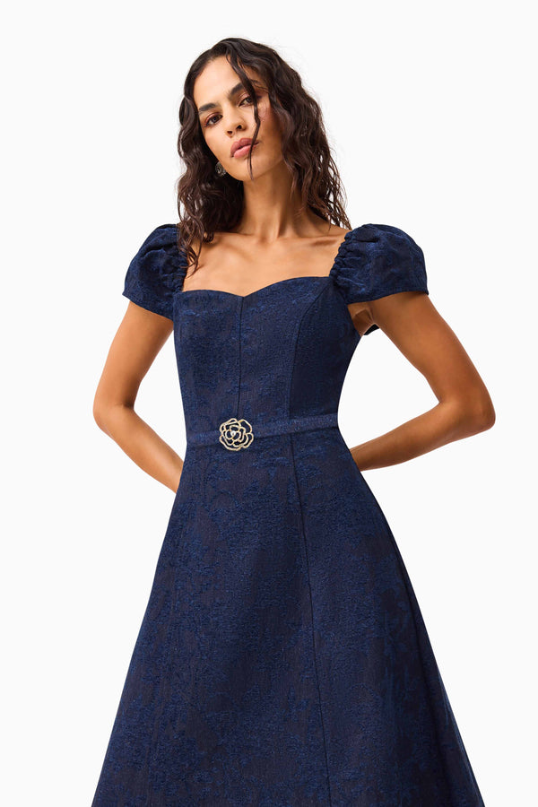Brunette model wearing Melody Jacquard Short Sleeve Midi Dress in Blue hands behind back shot