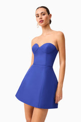 Brunette model wearing Beatrix Tulip Mini Dress in Blue posed shot