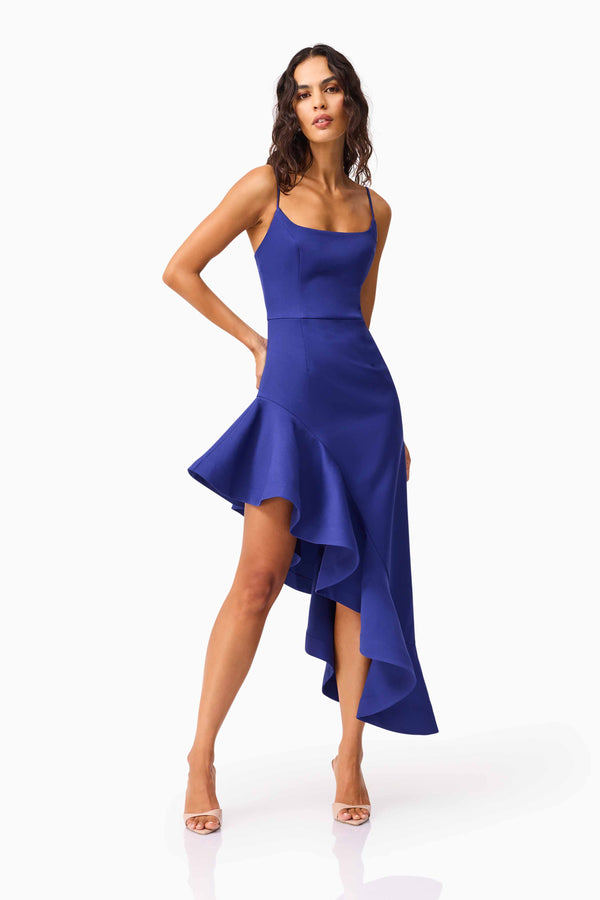 Brunette model wearing Beatrix Asymmetrical Gown in Blue hands on hip shot