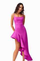 Brunette model wearing Beatrix Asymmetrical Gown in Purple hands behind back shot