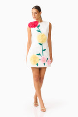 Brunette model wearing the Buttercup Embroidered Mini Dress in Ivory looking down shot