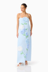 Brunette model wearing the Buttercup Embroidered Maxi Dress In Blue posed looking away shot