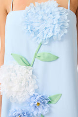 Brunette model wearing the Buttercup Embroidered Maxi Dress In Blue detail shot