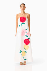 Brunette model wearing Buttercup Embroidered Maxi Dress in White front shot