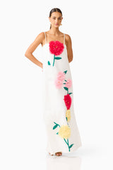 Brunette model wearing Buttercup Embroidered Maxi Dress in White posed hand on hip shot