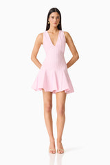 Brunette model wearing the Marla V-Neck Mini Dress in Pink posed shot